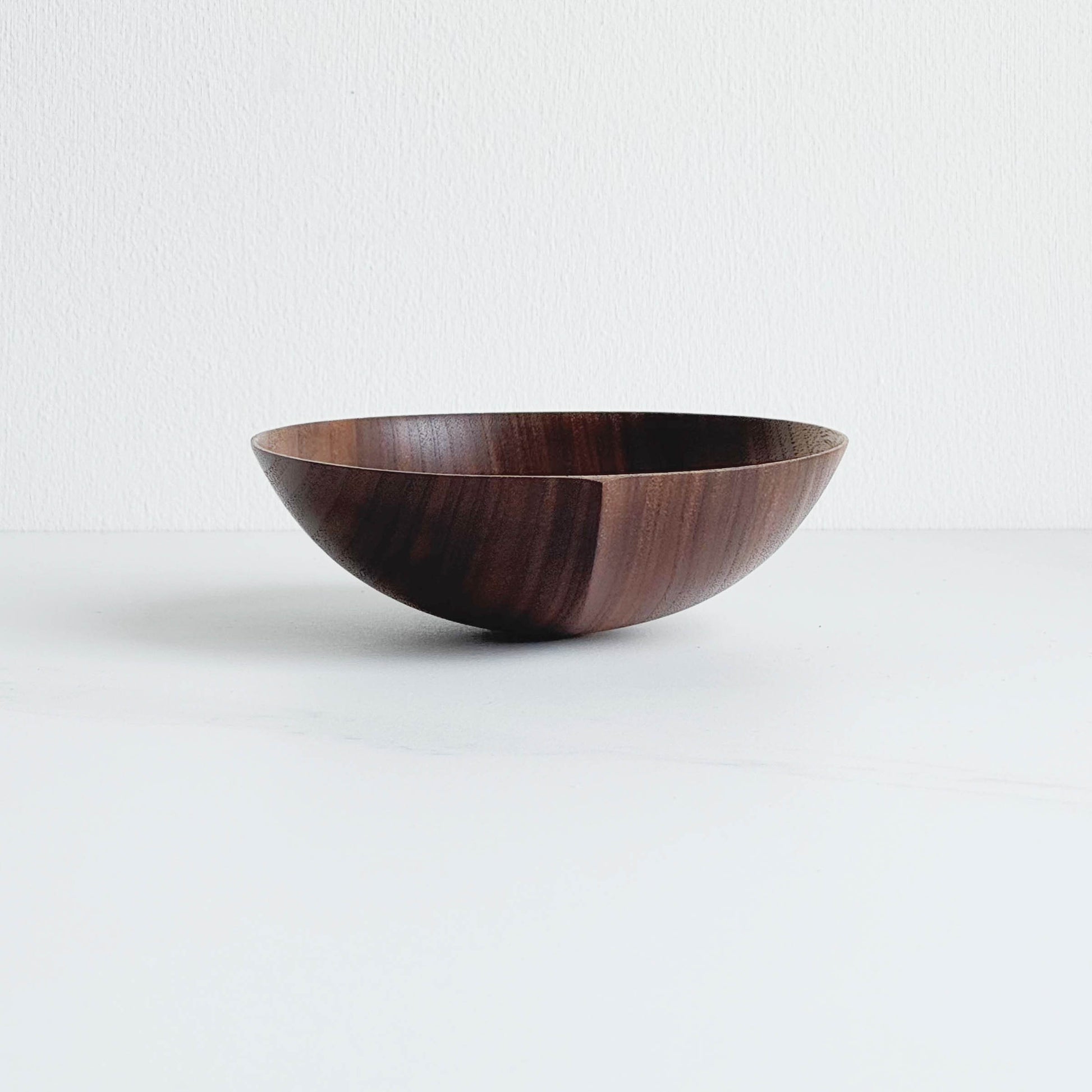 Walnut wooden bowl on a white background