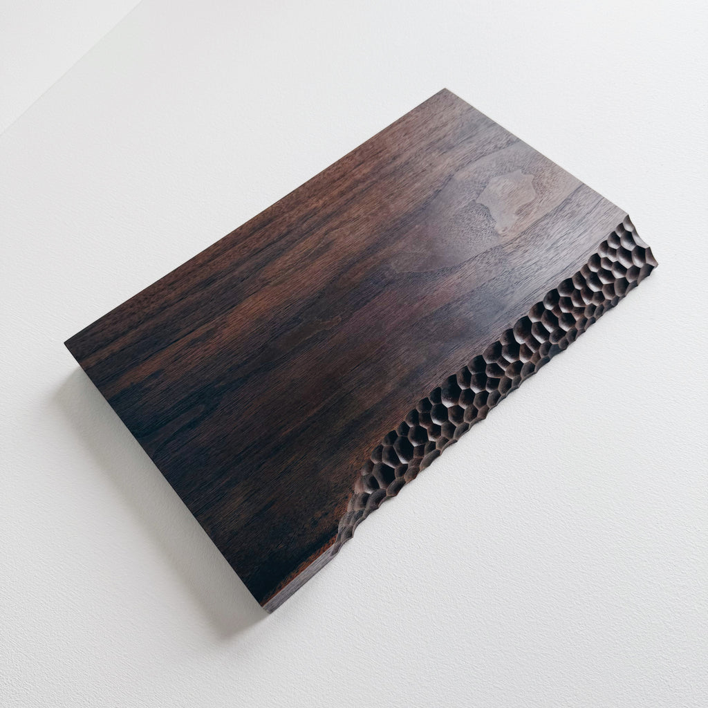 Black walnut presentation board with crater edge on a white background