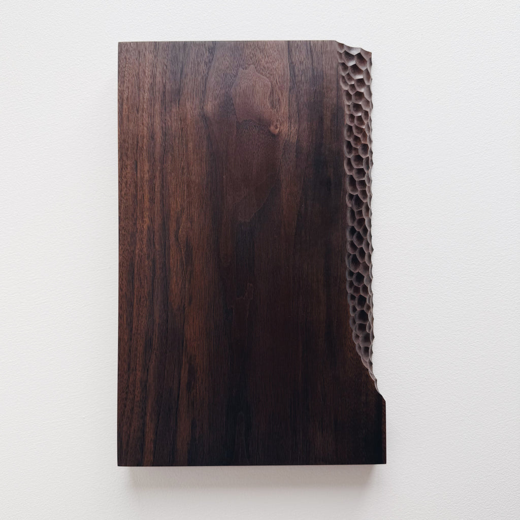 Black walnut presentation board with crater edge on a white background