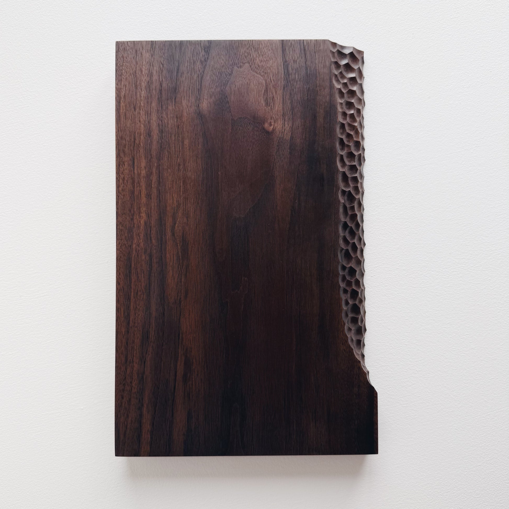 Black walnut presentation board with crater edge on a white background