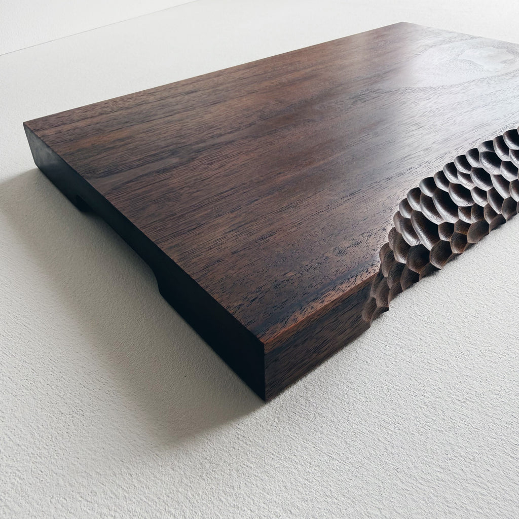 Black walnut board with crater edge on a white background