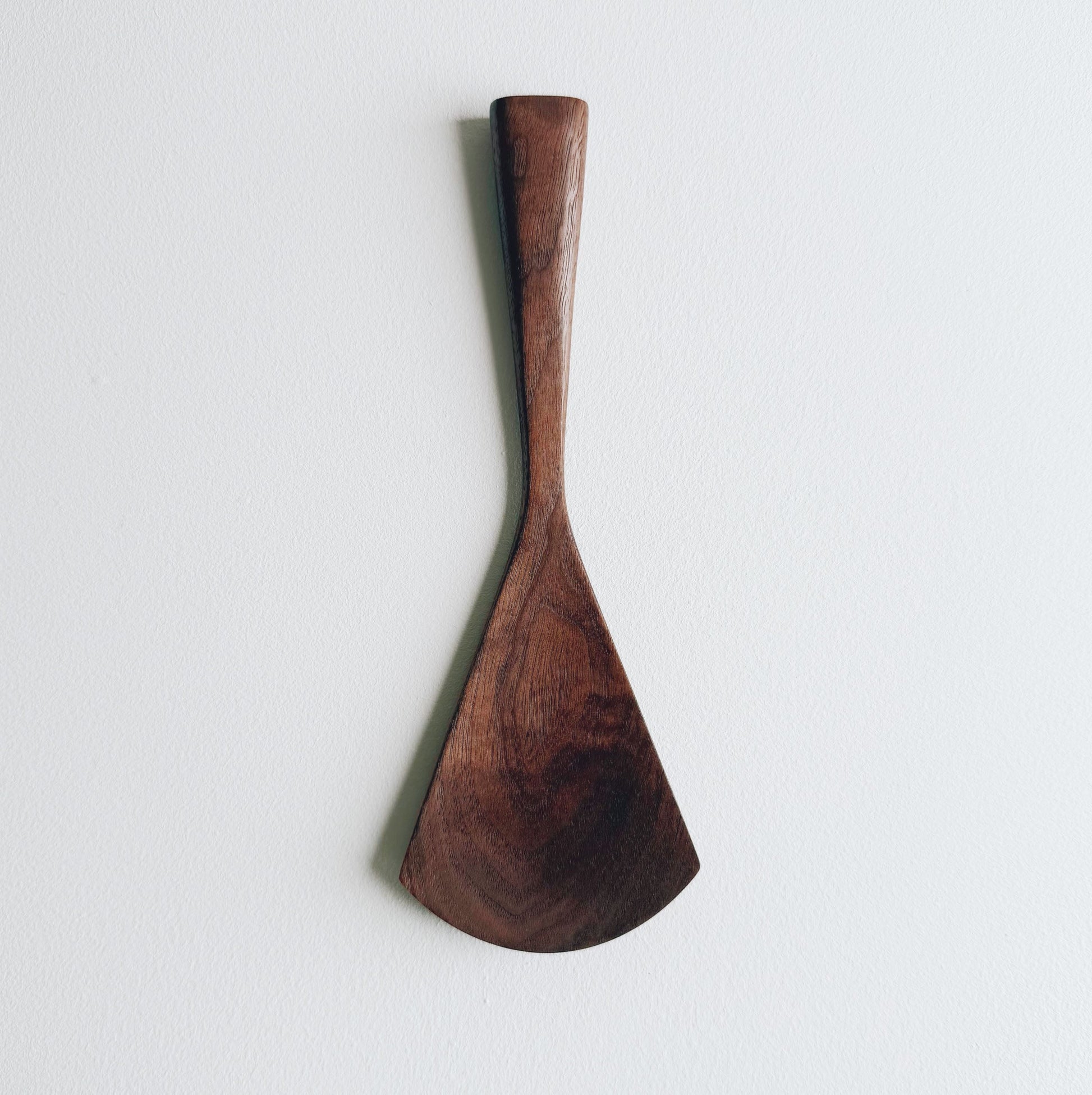 Walnut serving paddle on a light background