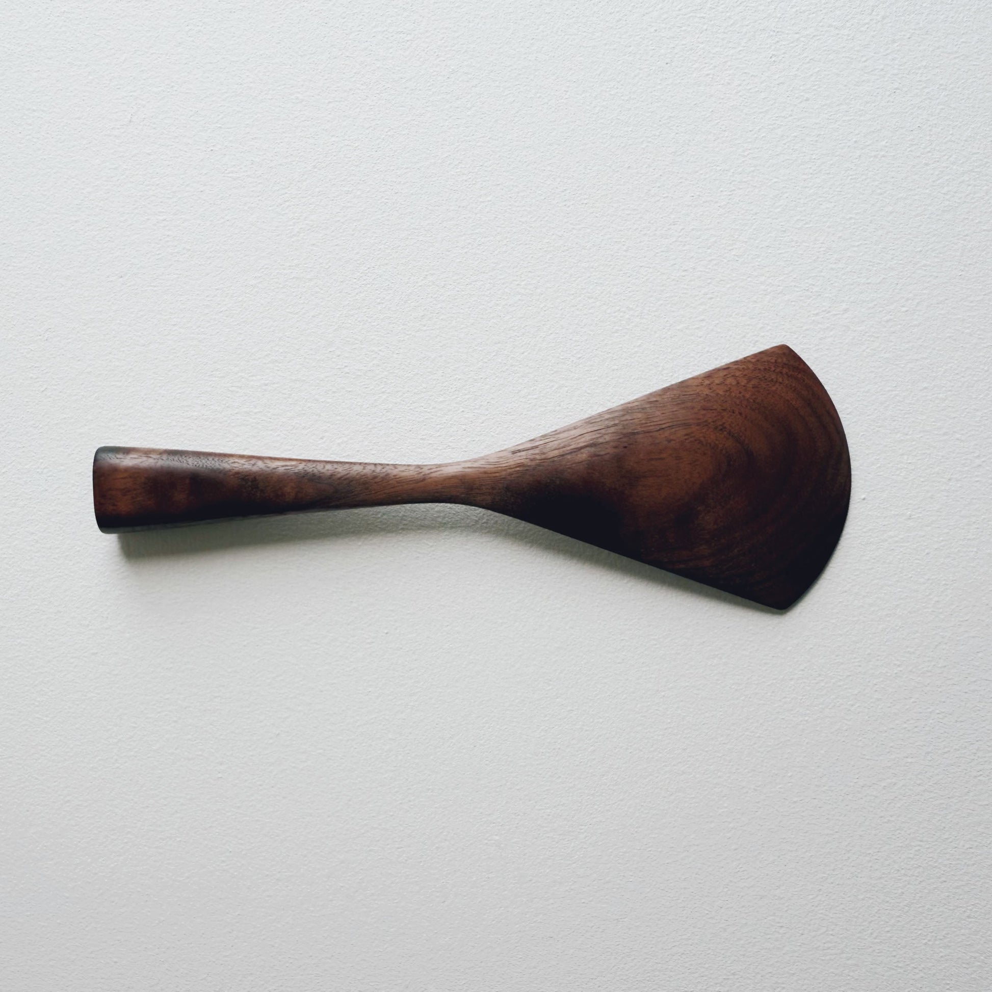 walnut serving paddle on a light background
