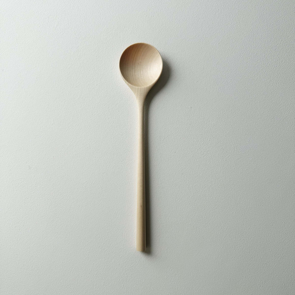 Sycamore serving spoon on a light background
