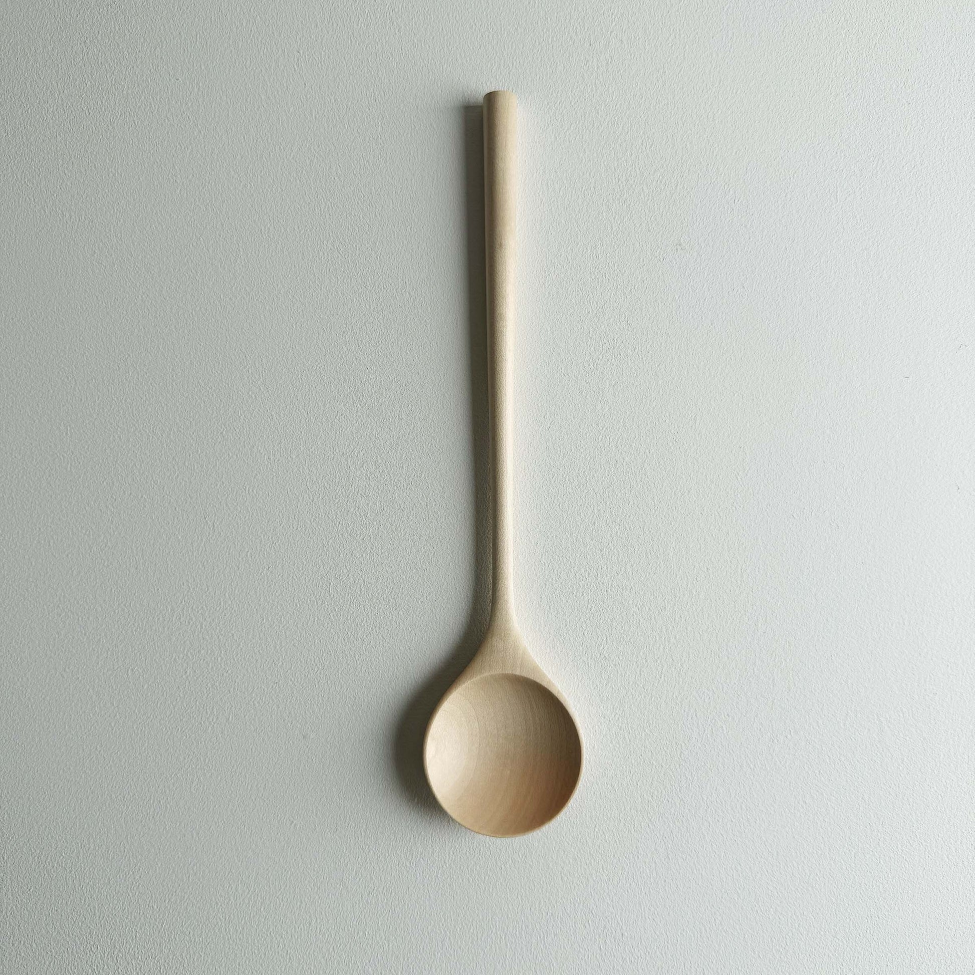 Sycamore serving spoon on a light background
