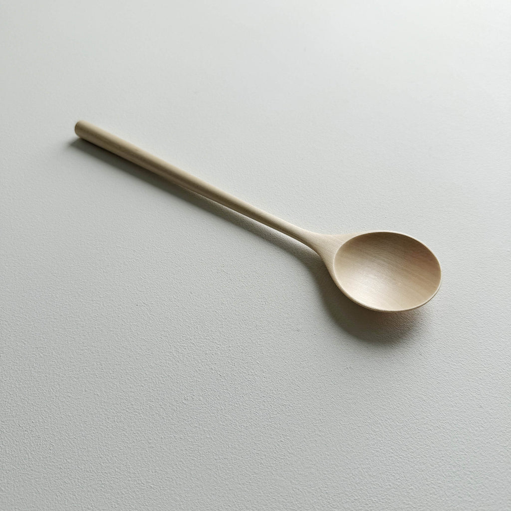 Sycamore serving spoon on a light background
