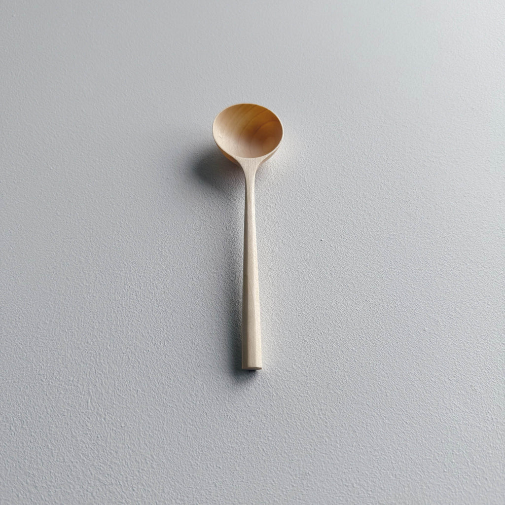 Sycamore wooden scoop on a white background