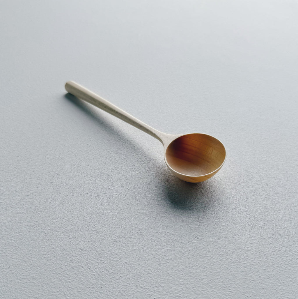 Sycamore wooden scoop on a white background
