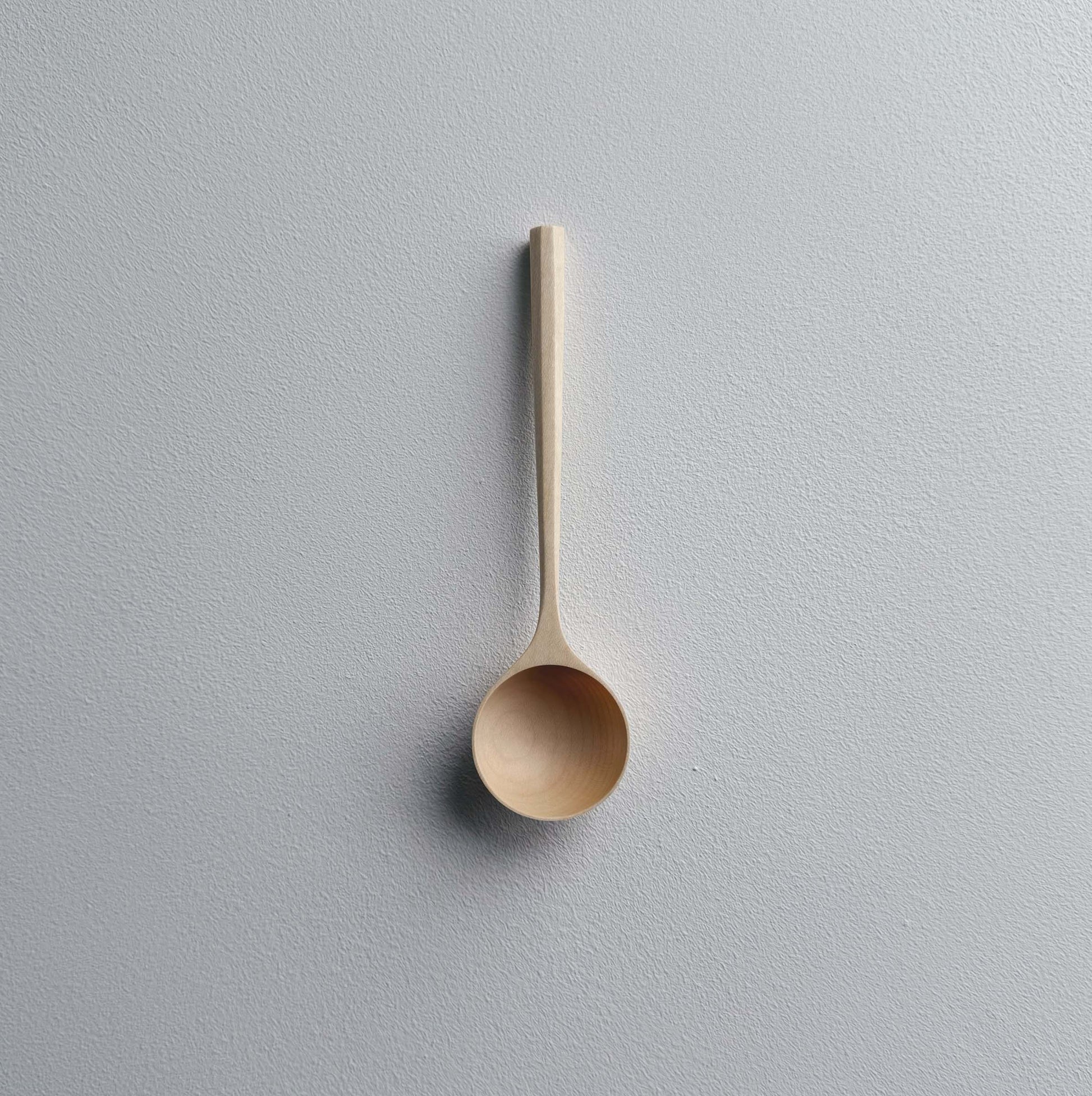 Sycamore wooden scoop on a white background
