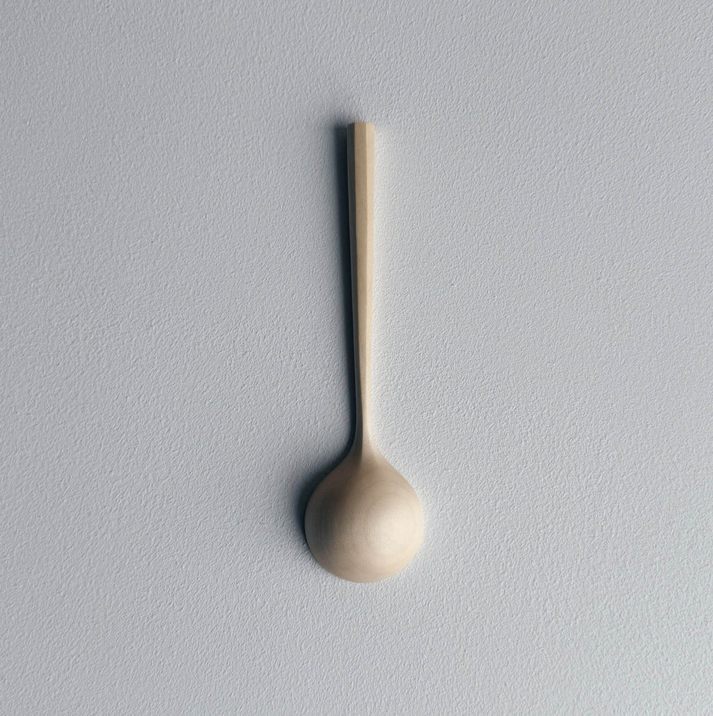 Sycamore wooden scoop on a white background
