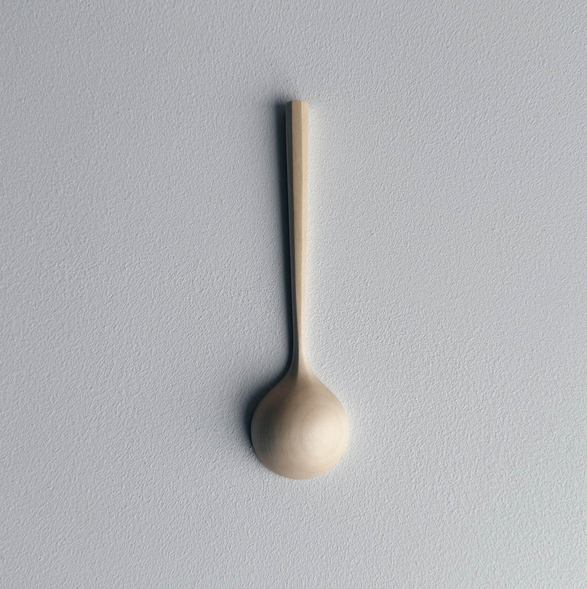 Sycamore wooden scoop on a white background

