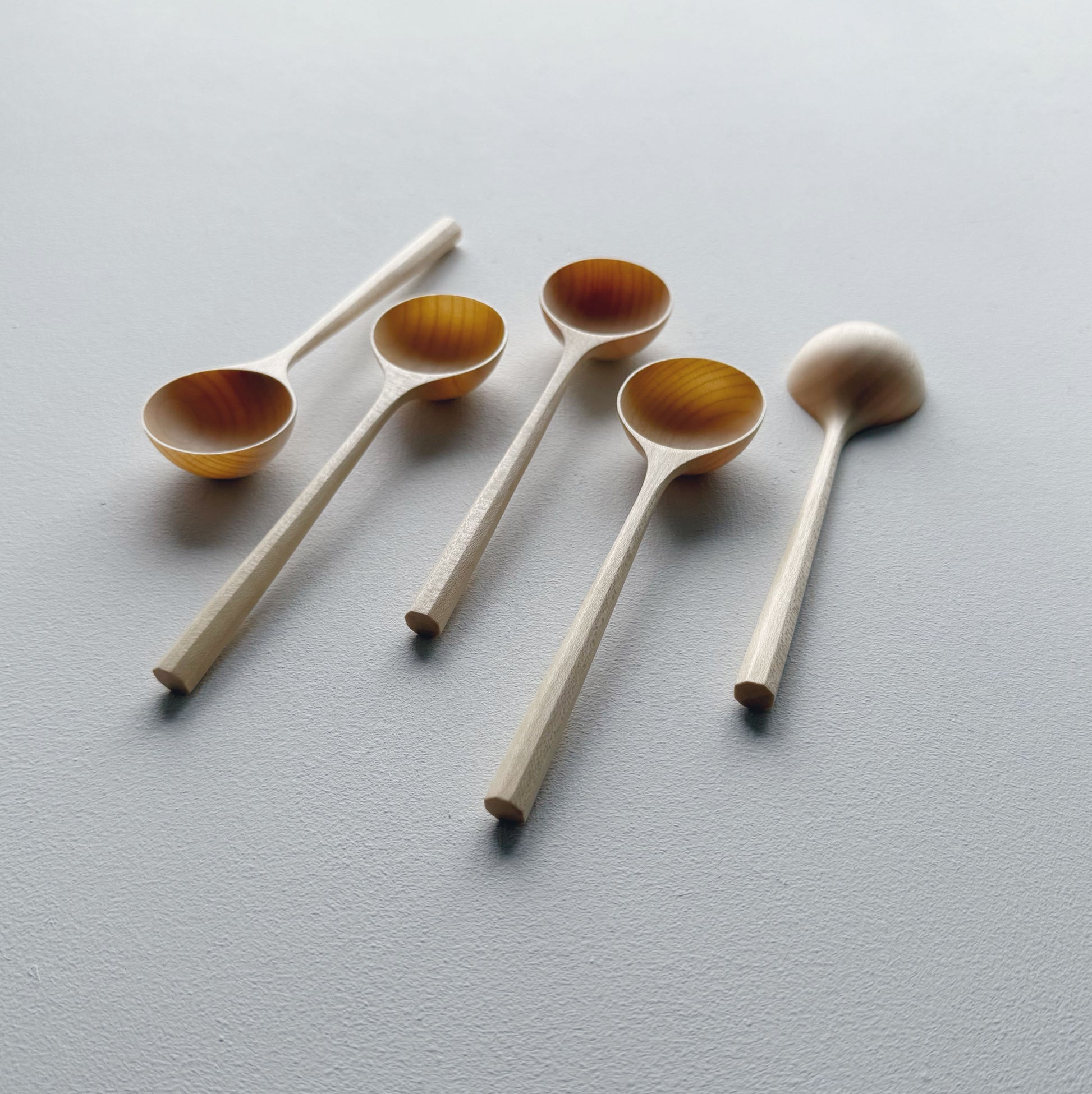 Set of sycamore wooden scoops on a white background
