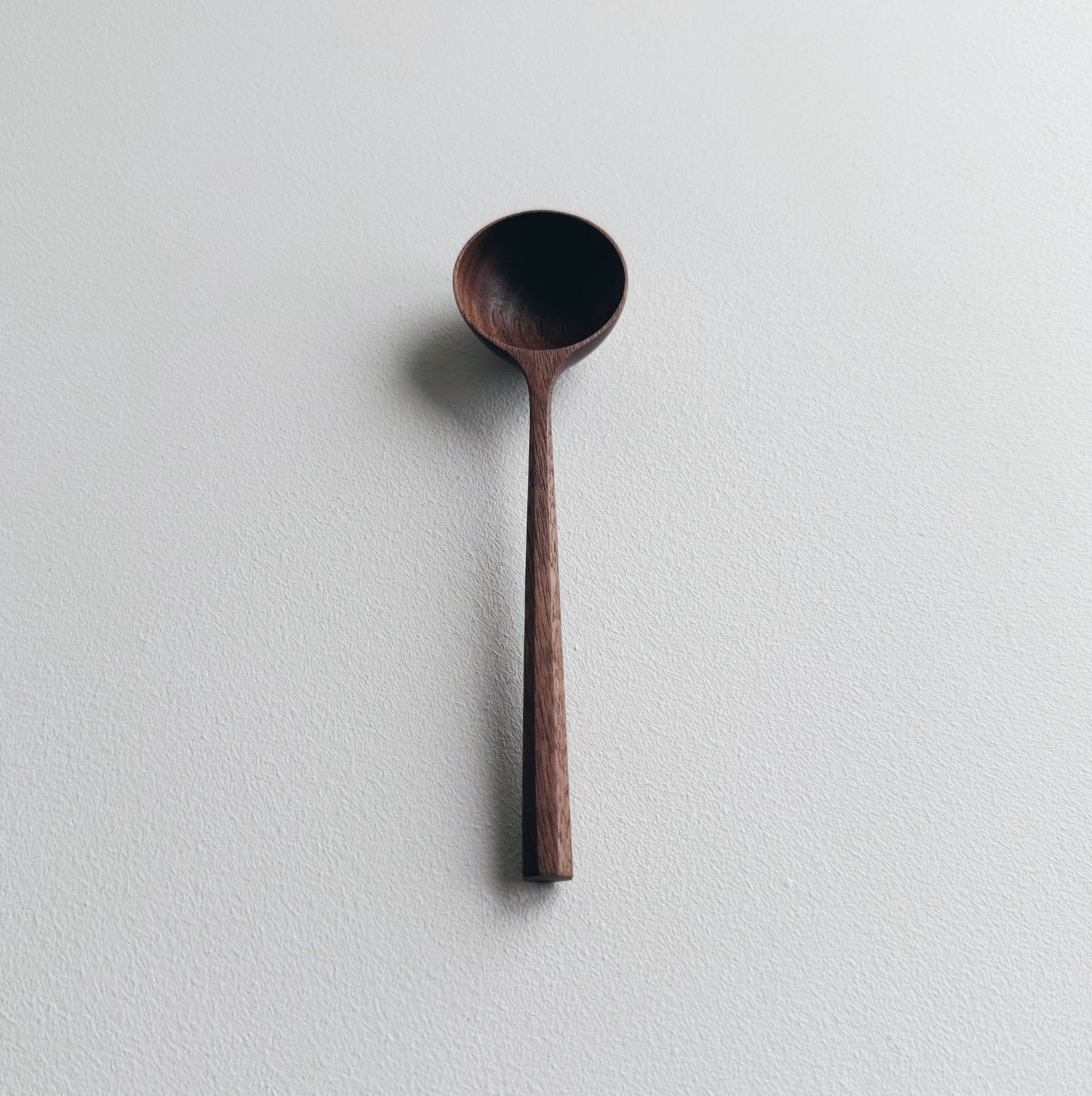 Walnut wood scoop on a white background
