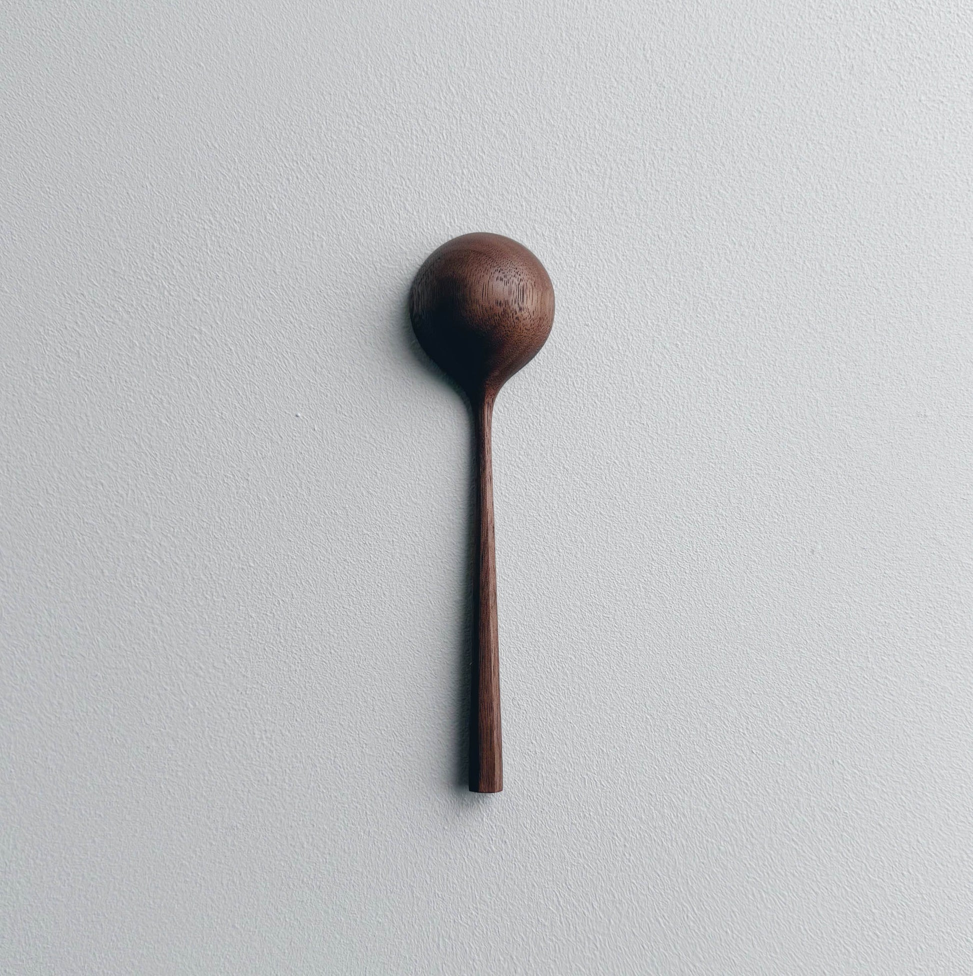Walnut wood scoop on a white background