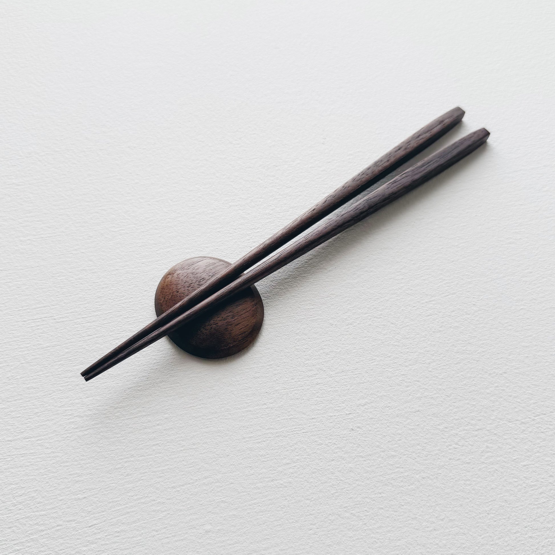 Small tapered chopsticks with pebble rest in vintage black walnut