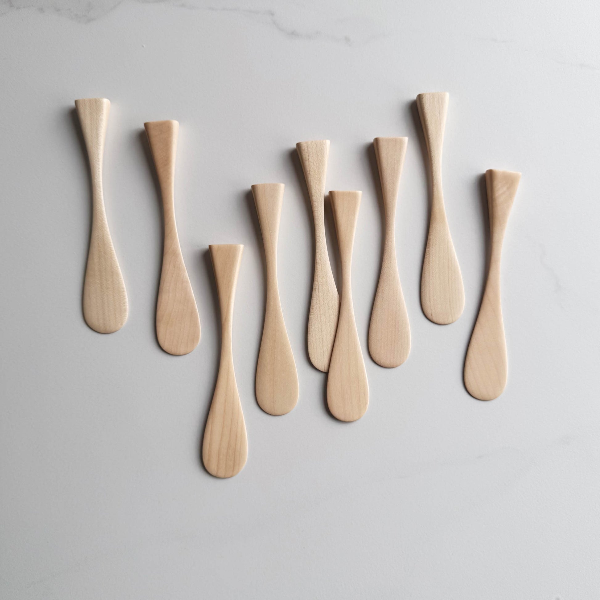 Sycamore wood butter knives on a white background
