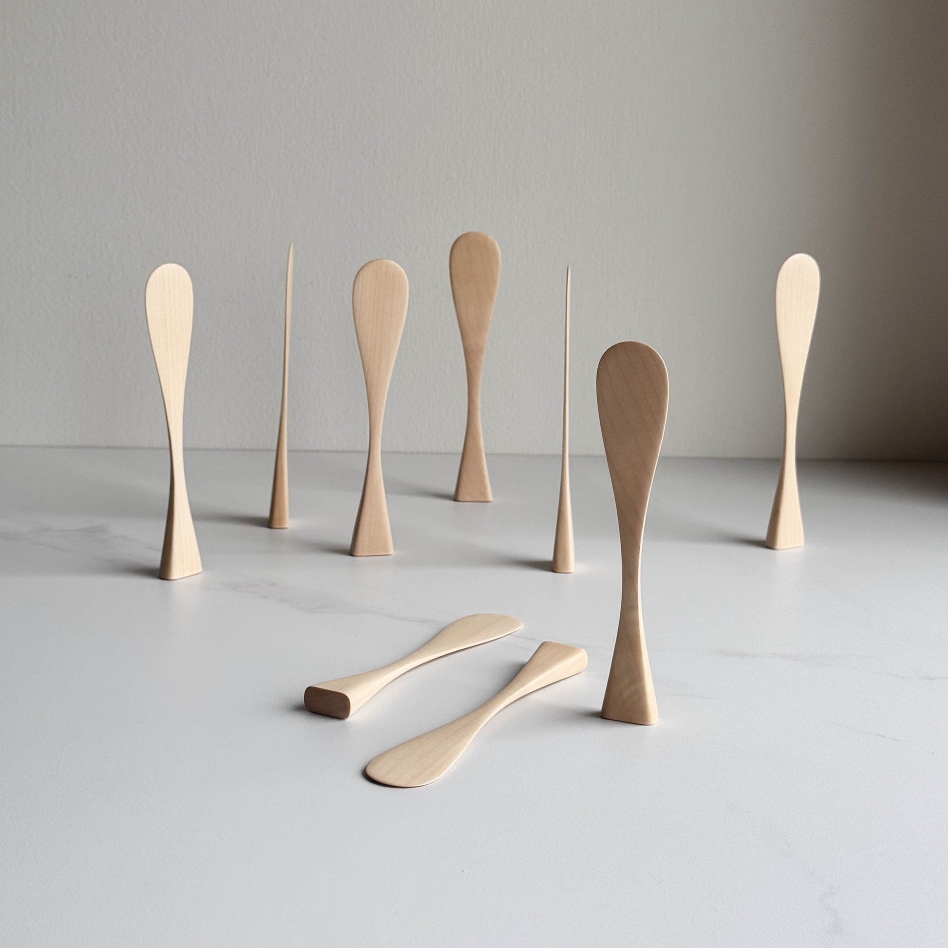 Sycamore wood butter knives on a white background
