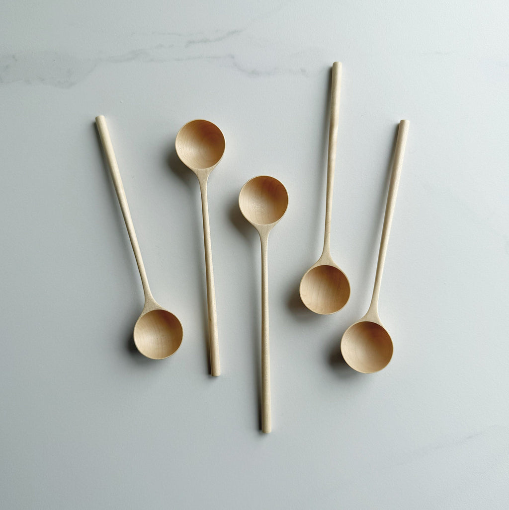 Set of five sycamore long stem spoons on a light background