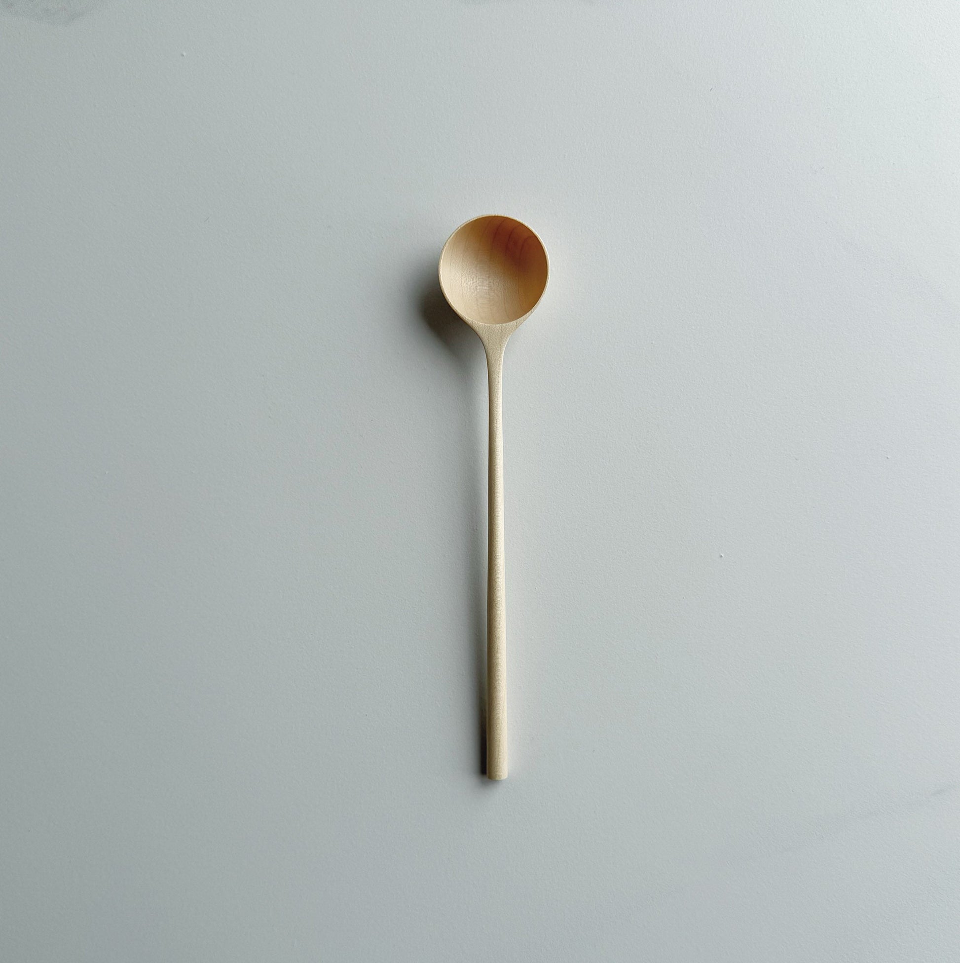 Sycamore long stem spoon on a light background
