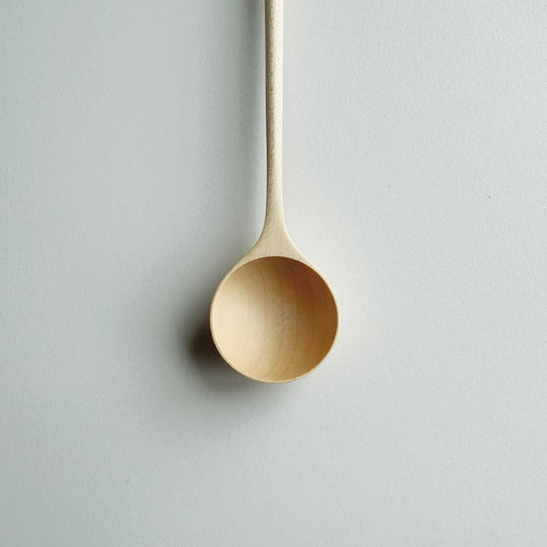 Close up of sycamore long stem spoon on a light background
