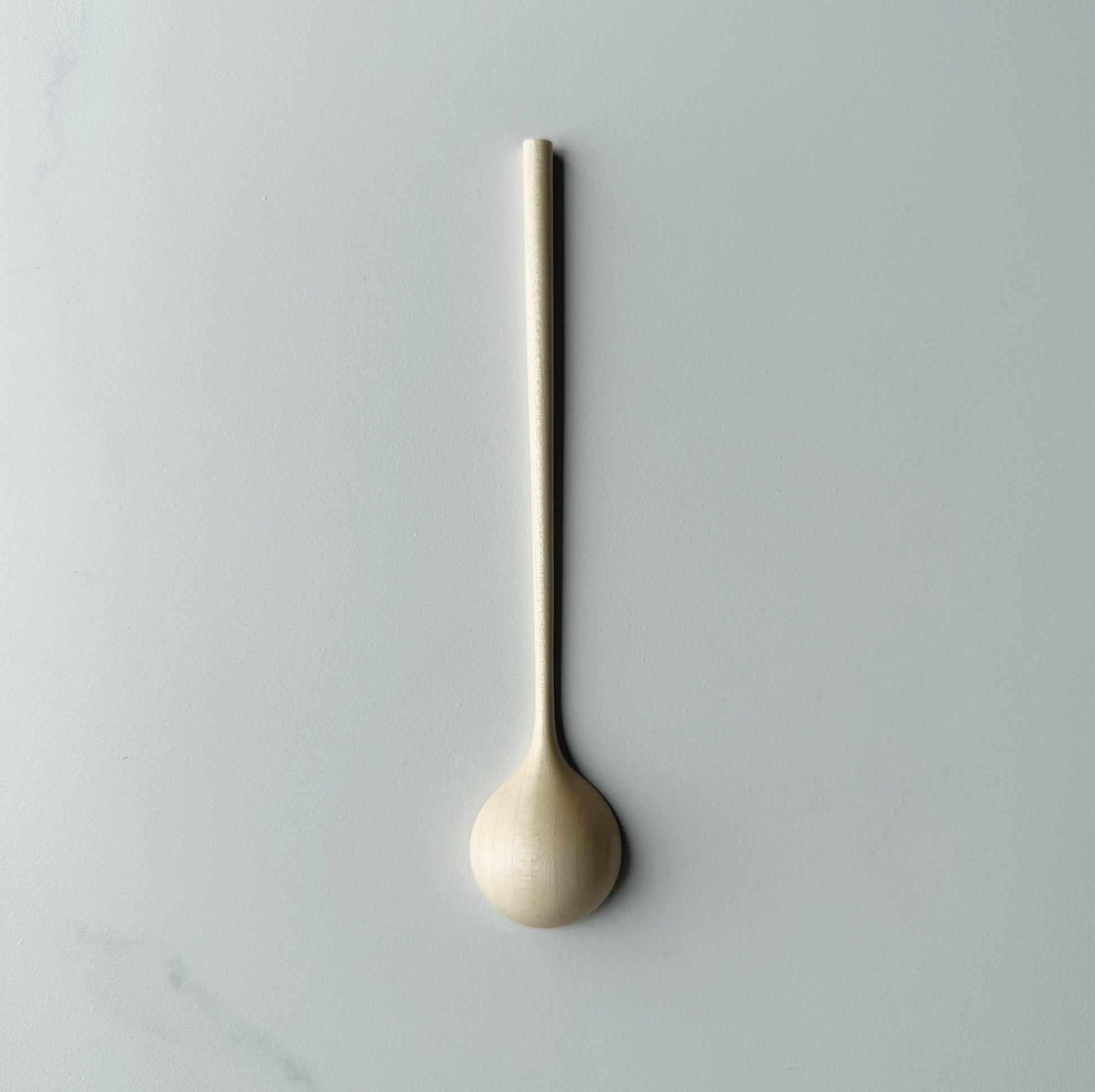 Sycamore long stem spoon on a light background
