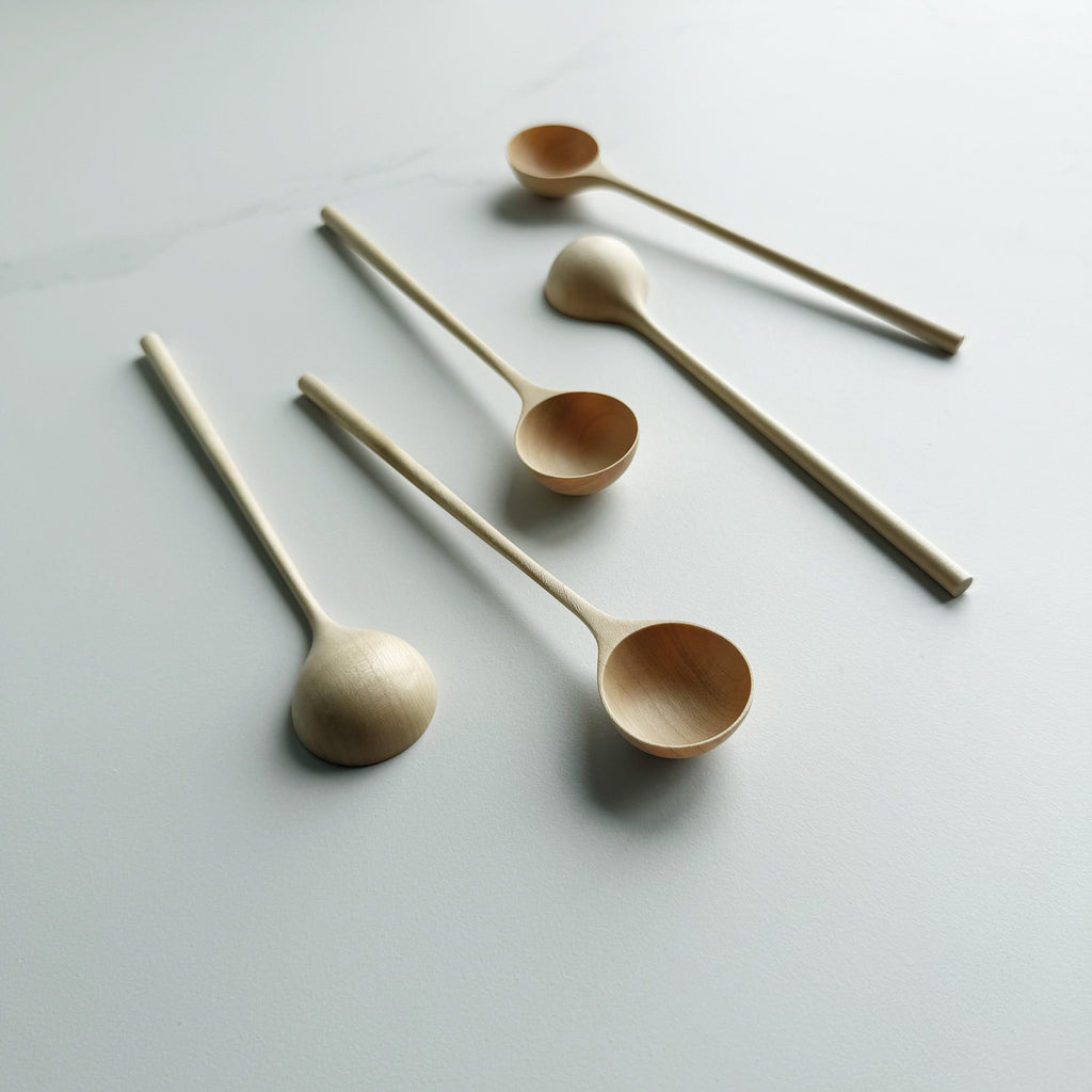 Set of five sycamore long stem spoons on a light background