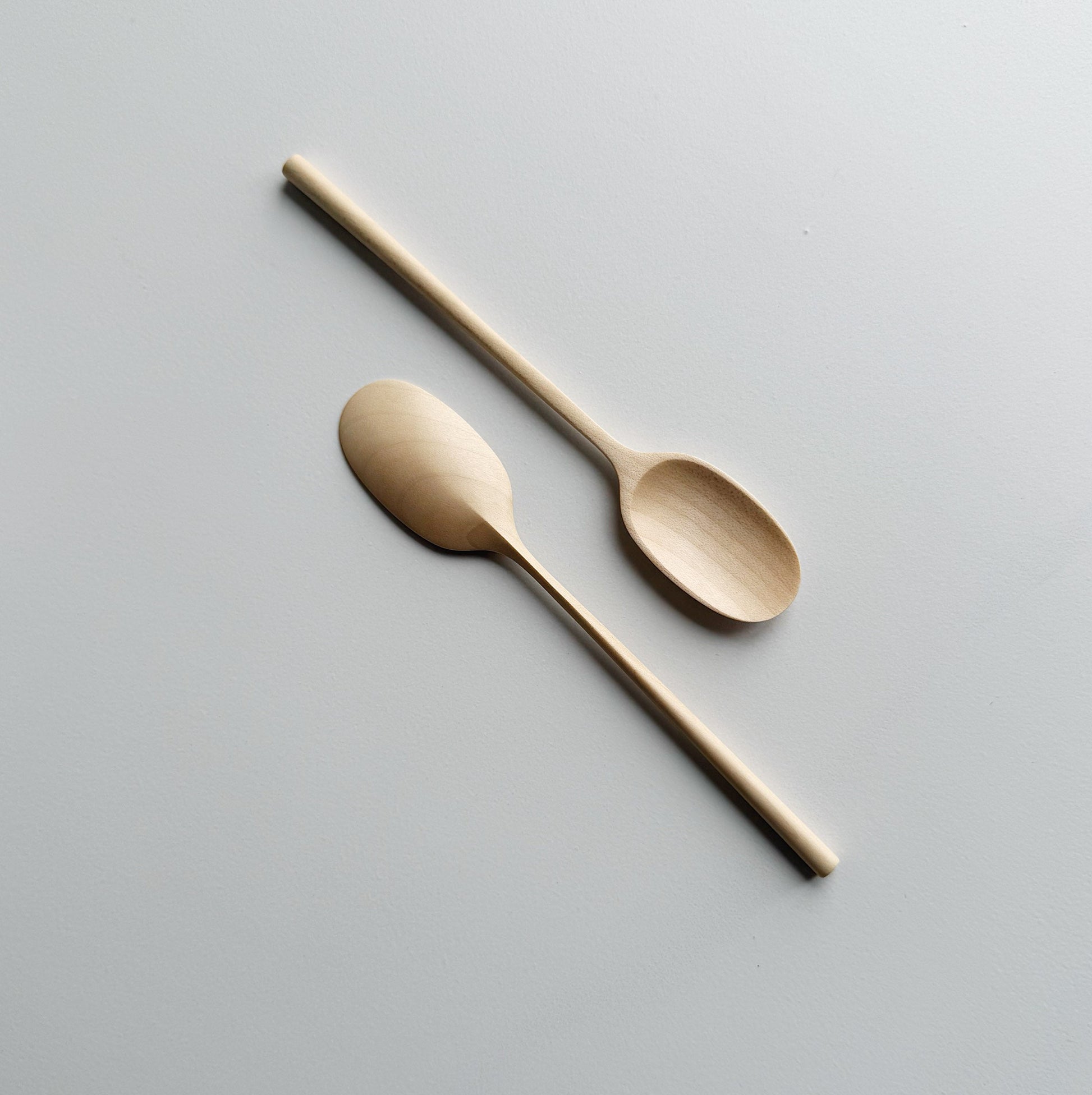 Pair of sycamore small paddle spoon on a light background
