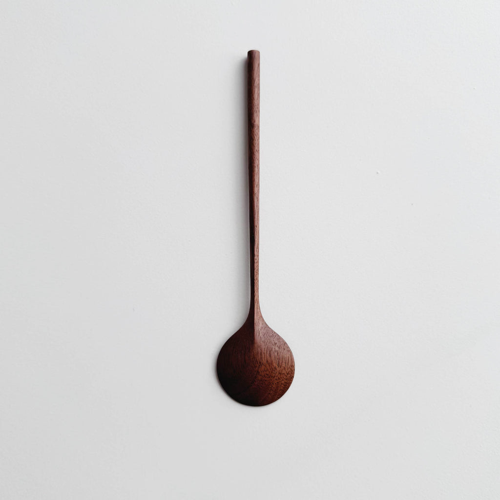 Walnut wooden spoon on a white background
