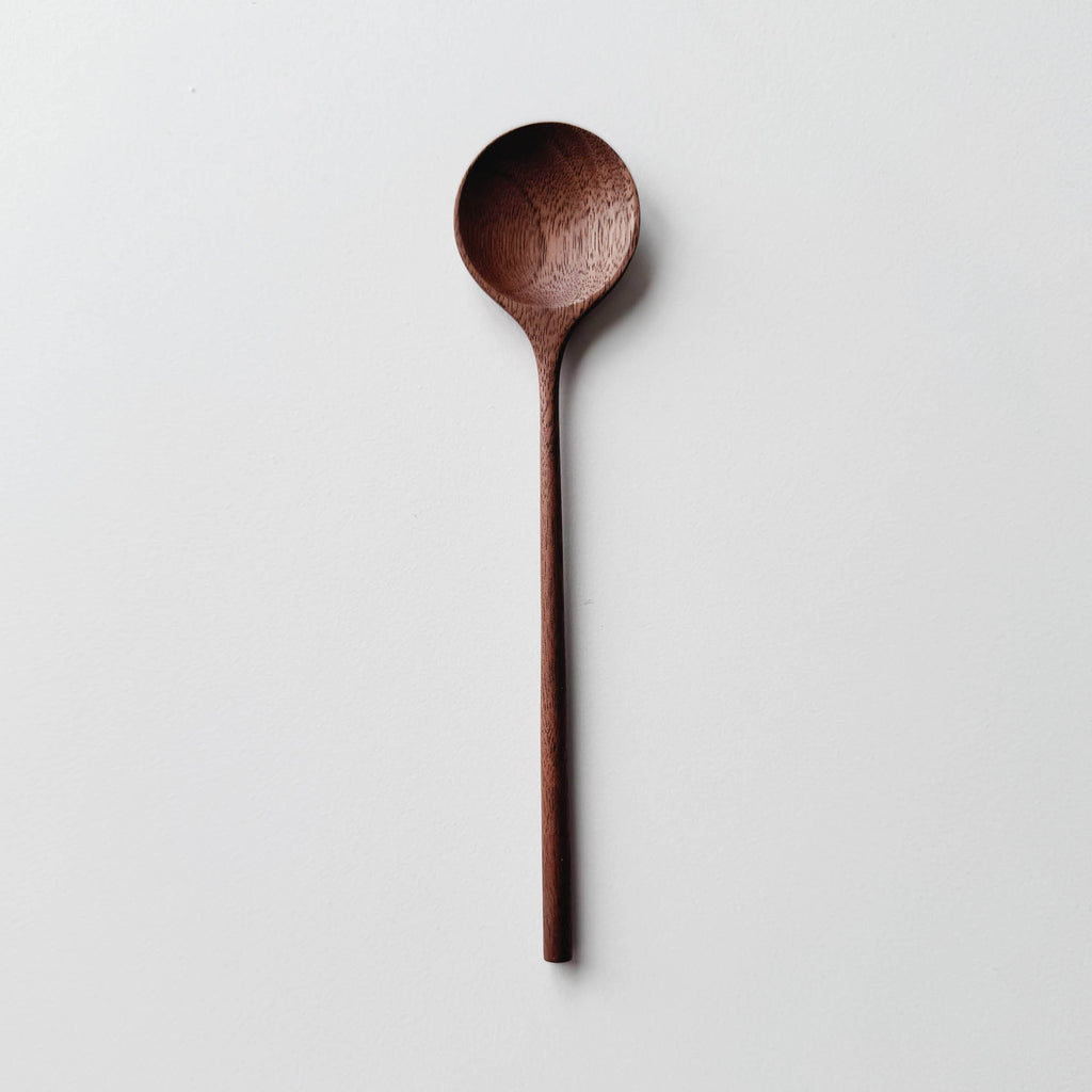 Walnut wooden spoon on a white background

