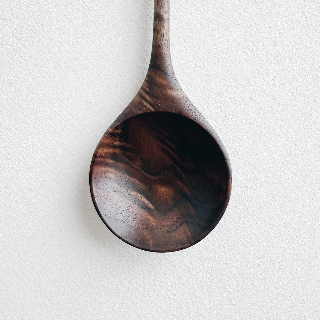 Walnut wooden spoon on a white background
