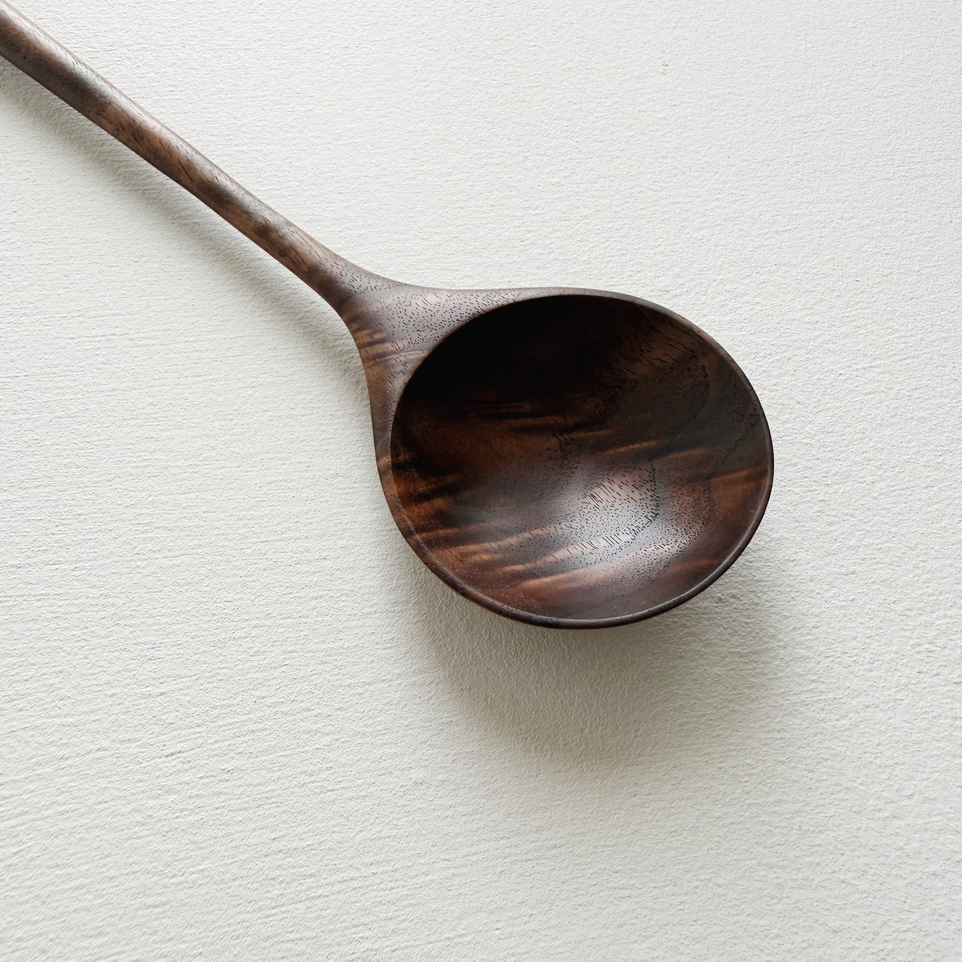 Walnut wooden spoon on a white background