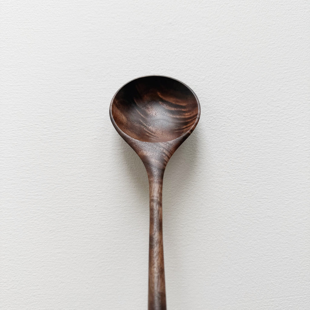 Walnut wooden spoon on a white background