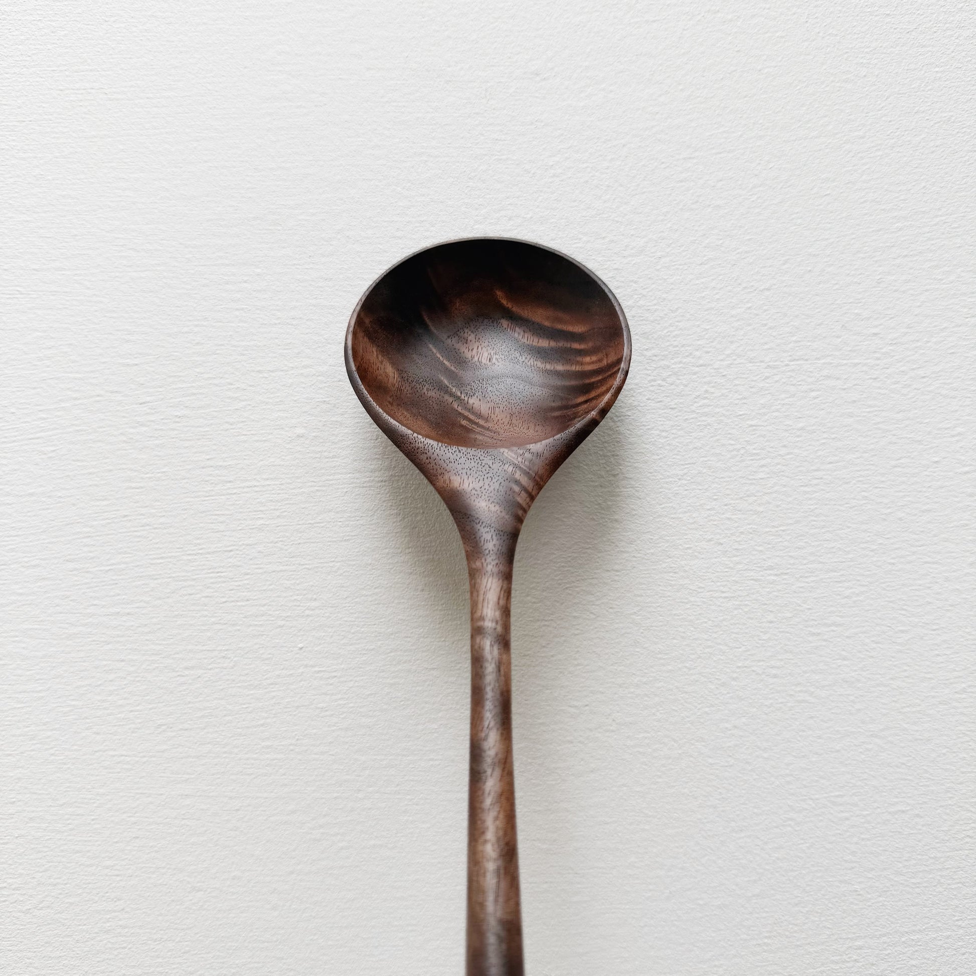 Walnut wooden spoon on a white background