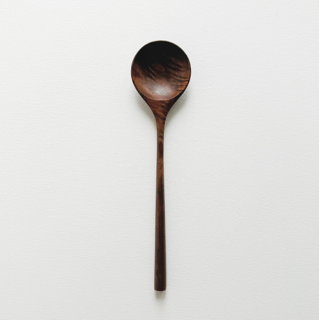 Walnut wooden spoon on a white background