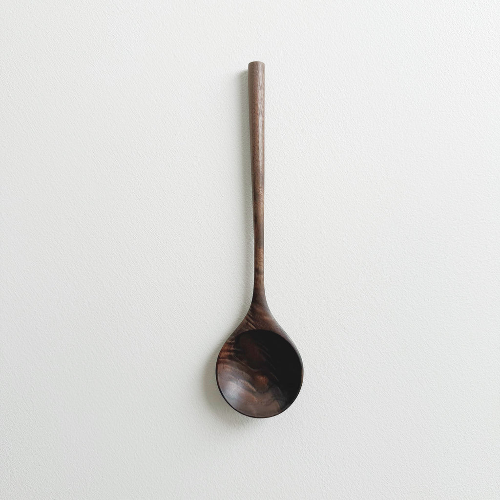 Walnut wooden spoon on a white background