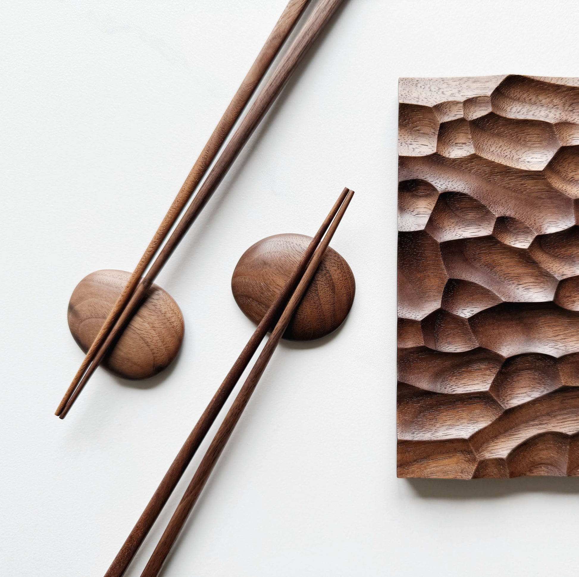 Wide presentation board with crater design in walnut, with wooden chopsticks & pebble rests.