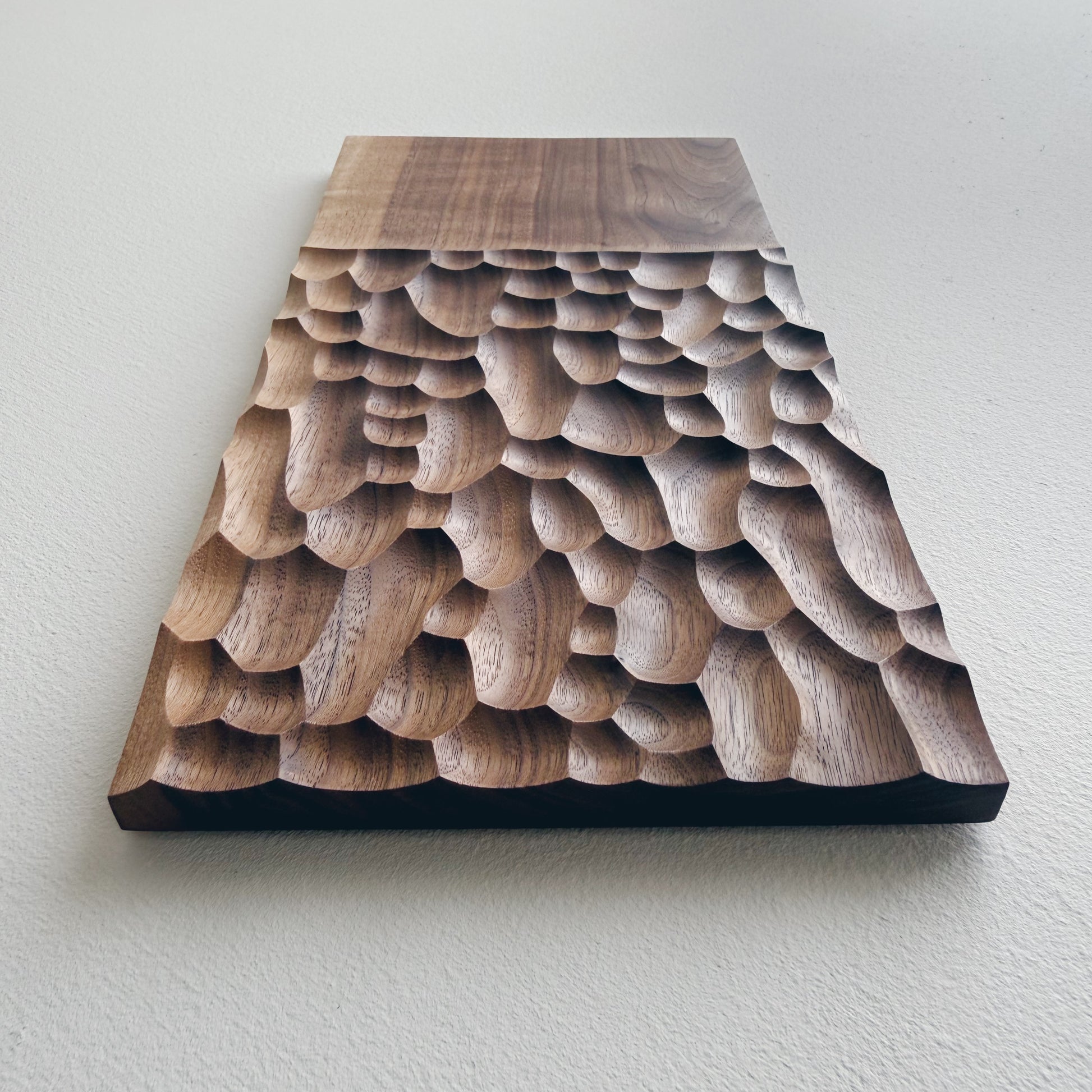 Two tone walnut presentation board on a white background 