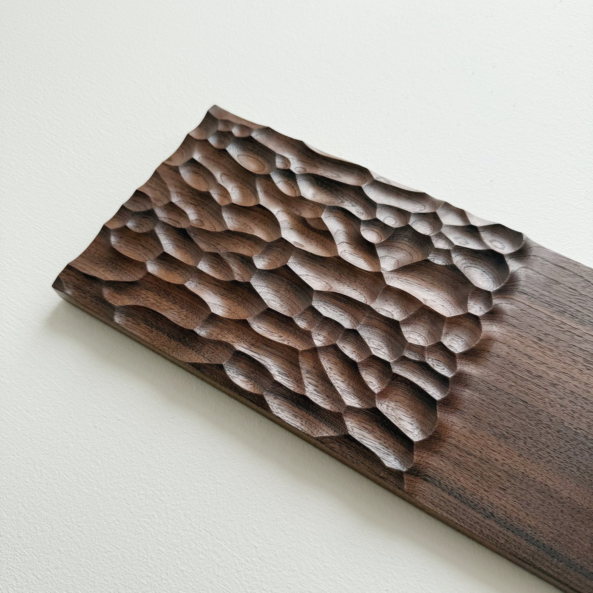 Wide walnut presentation board on a white background
