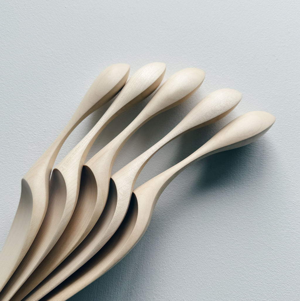 A collection of sycamore cake servers on a light background
