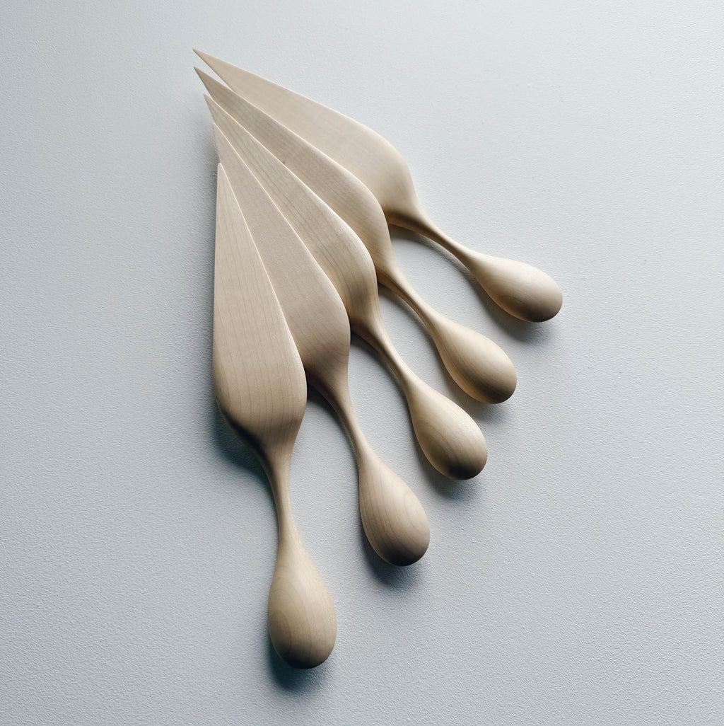 A collection of sycamore cake servers on a light background

