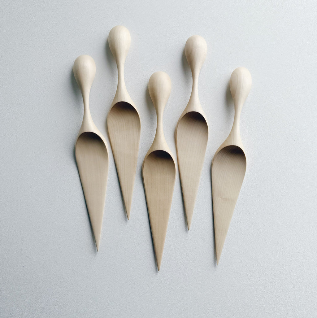A collection of sycamore cake servers on a light background
