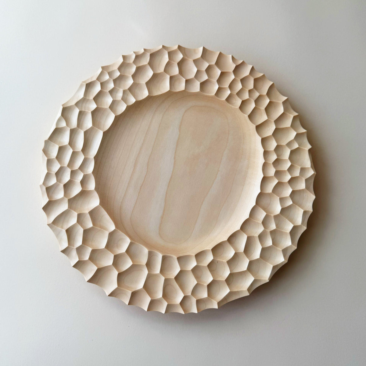 Crater charger plate in sycamore