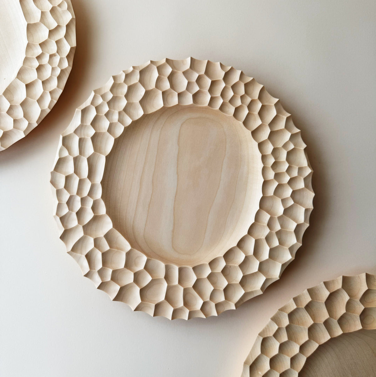 Crater charger plate in sycamore
