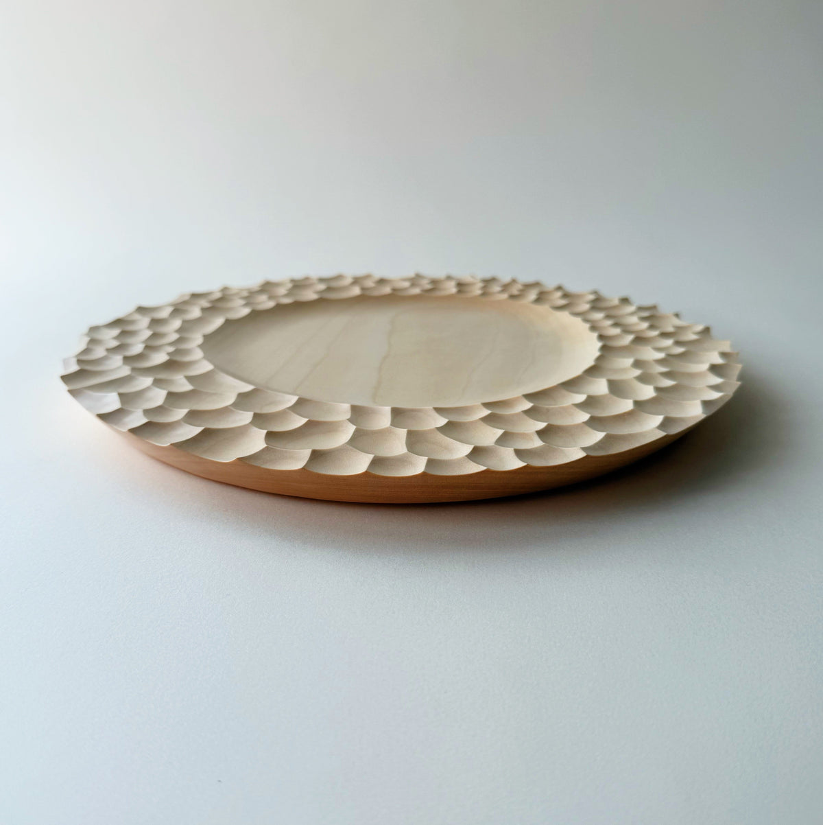 Crater charger plate in sycamore