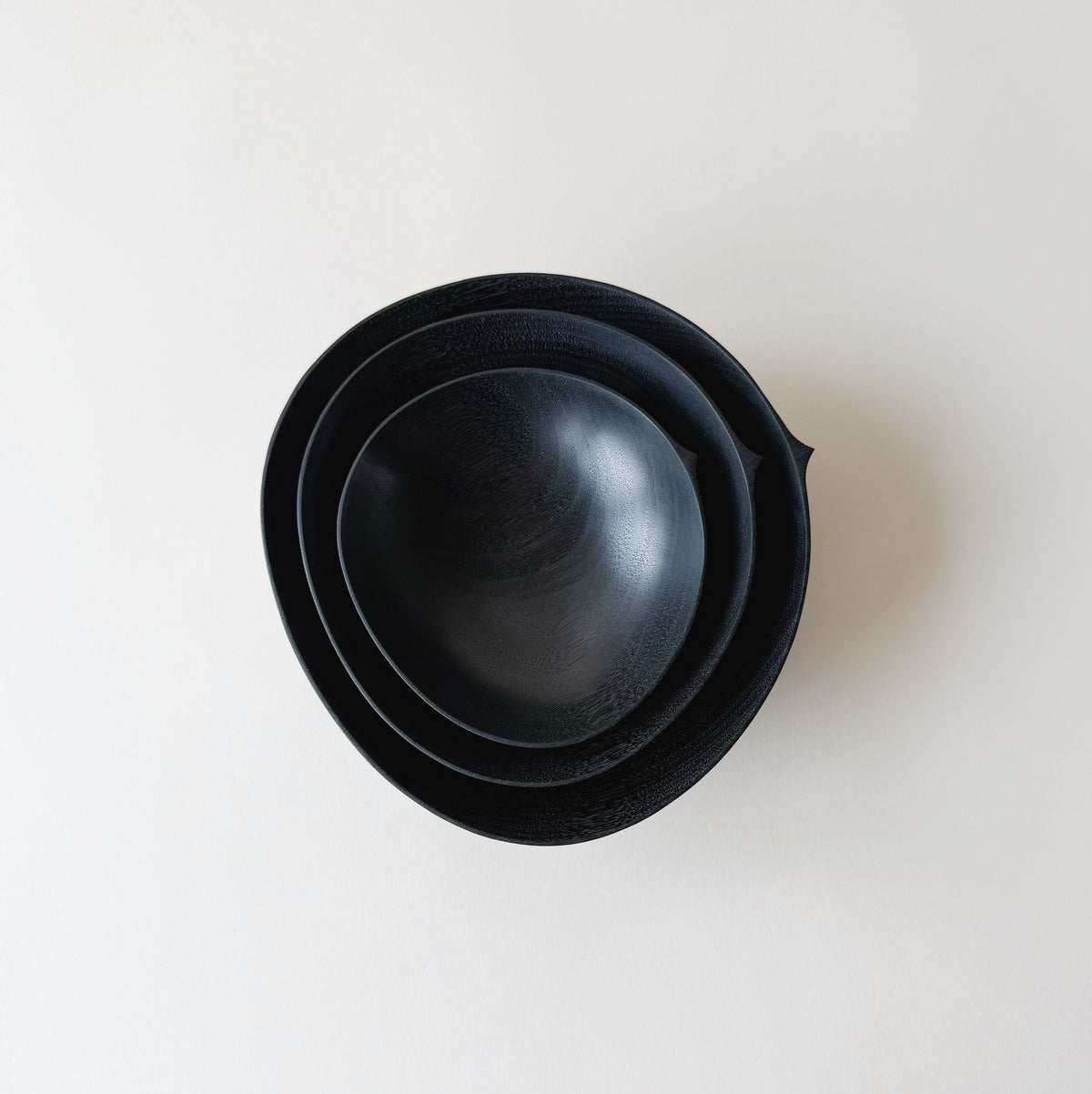 Oval nesting bowls in ebonised walnut - set of three
