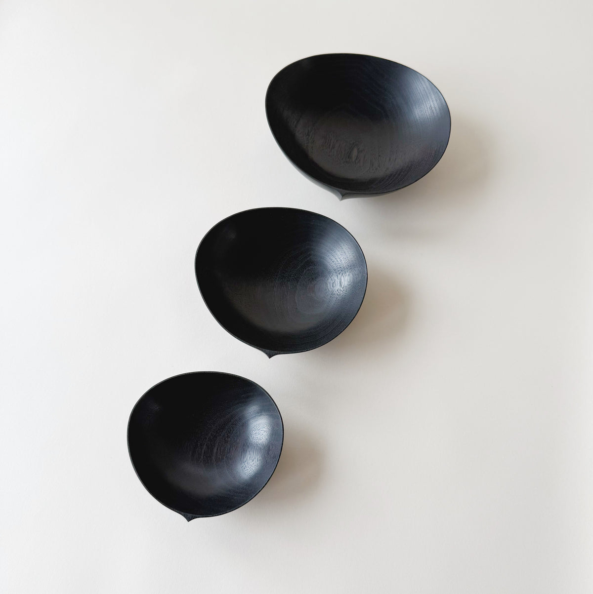 Oval nesting bowls in ebonised walnut - set of three