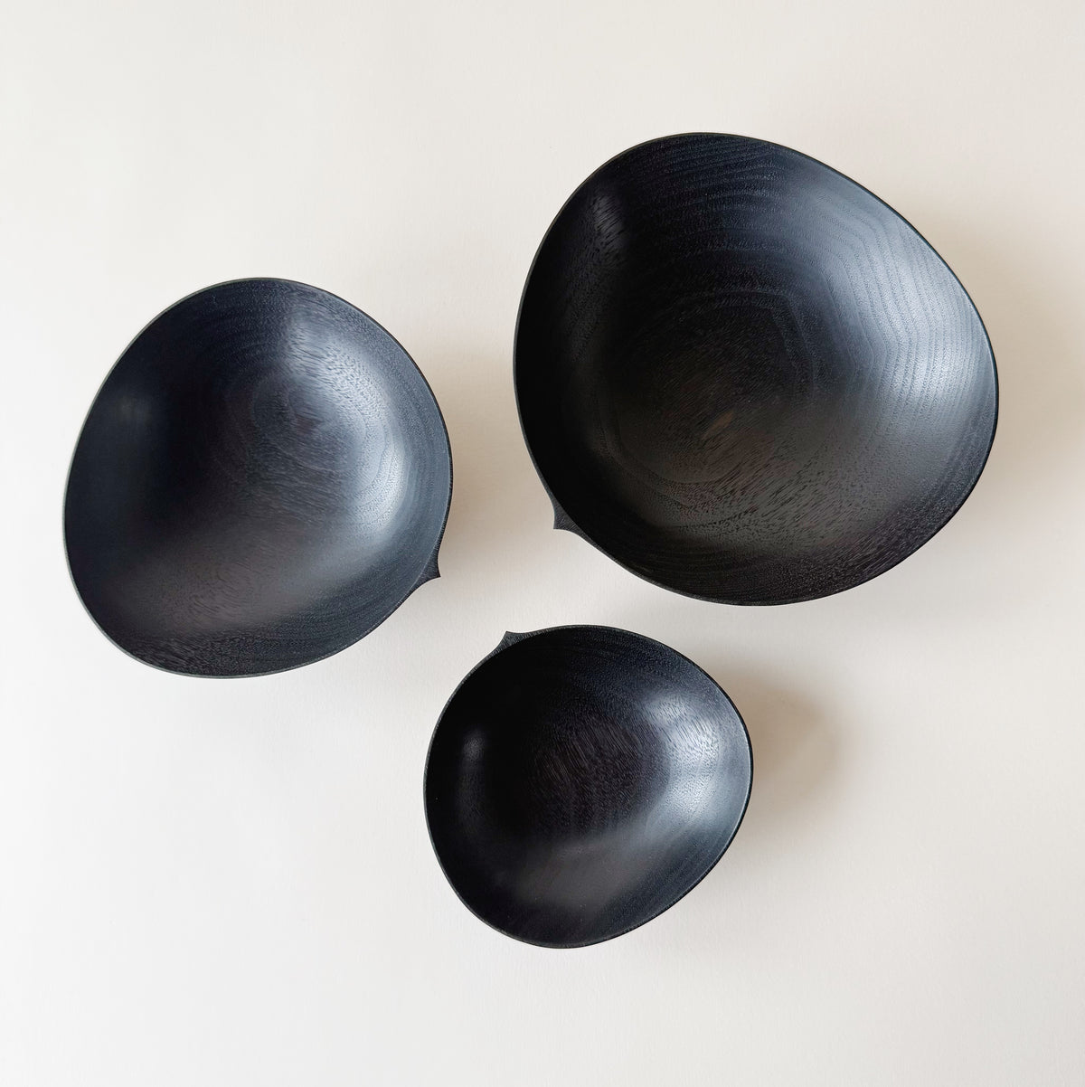 Oval nesting bowls in ebonised walnut - set of three