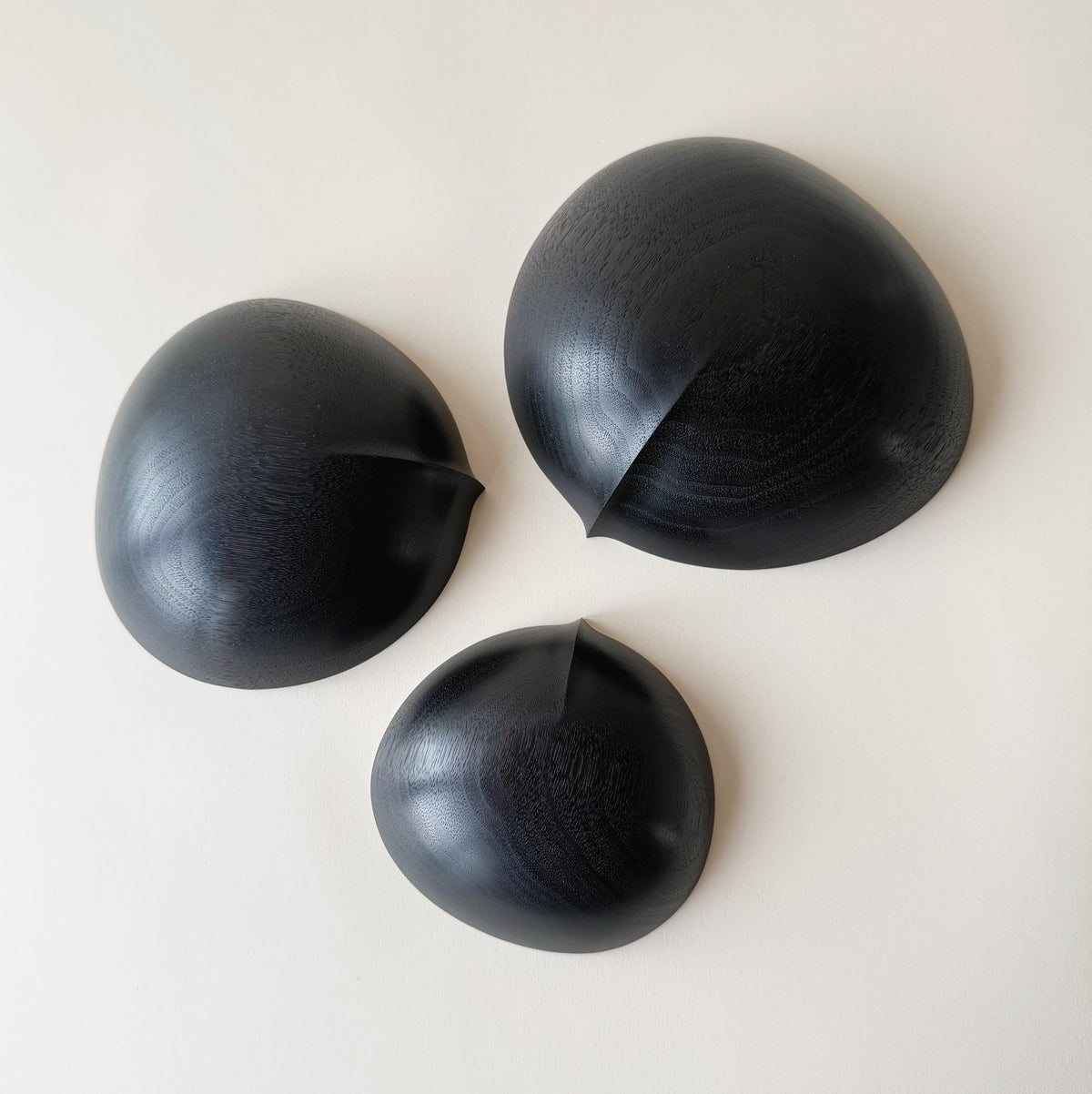 Oval nesting bowls in ebonised walnut - set of three