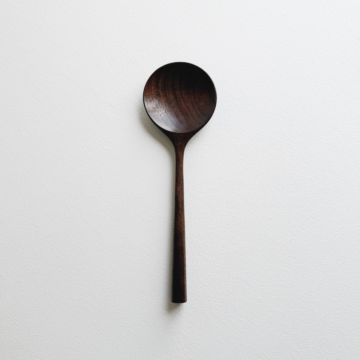 Serving spoon in dark walnut