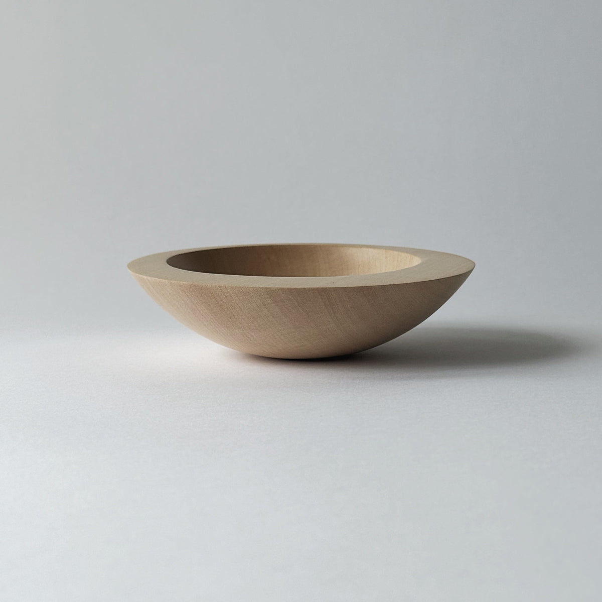 Tilted crescent bowl in sycamore